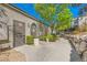 A charming exterior with well maintained landscape, stucco wall, and walking path at 950 Seven Hills Dr # 2014, Henderson, NV 89052
