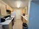 Well-lit kitchen with light wood cabinets, tile flooring, white appliances, and black gas range at 950 Seven Hills Dr # 2014, Henderson, NV 89052