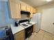 Bright kitchen featuring light wood cabinets, gas range, and tile flooring, with modern appliances at 950 Seven Hills Dr # 2014, Henderson, NV 89052