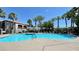 Community pool surrounded by palm trees and lounge chairs at 950 Seven Hills Dr # 2014, Henderson, NV 89052