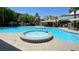 Community pool with jacuzzi and ample seating areas and palm trees at 950 Seven Hills Dr # 2014, Henderson, NV 89052