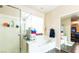 Clean bathroom features a soaking tub with glass shower door, perfect for relaxation and rejuvenation at 9856 Chief Sky St, Las Vegas, NV 89178