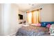 Bedroom featuring a full sized bed, dresser, ceiling fan, and a window that provides ample natural light at 9856 Chief Sky St, Las Vegas, NV 89178