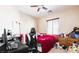 This is a bedroom with beige walls, a ceiling fan, and a window with blinds at 9856 Chief Sky St, Las Vegas, NV 89178