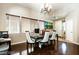 Bright dining room with hardwood floors, large windows, and modern decor at 9856 Chief Sky St, Las Vegas, NV 89178