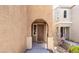 Inviting front entrance featuring an arched entryway and well-maintained facade at 9856 Chief Sky St, Las Vegas, NV 89178