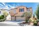 Two-story home featuring a neutral exterior, attached garage, and well-maintained landscaping at 9856 Chief Sky St, Las Vegas, NV 89178