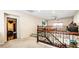 Open hallway boasts decorative iron railing, plush carpeting, and easy access to the bedrooms and second floor at 9856 Chief Sky St, Las Vegas, NV 89178