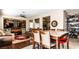 Open concept living room and dining area with neutral tones and hardwood floors at 9856 Chief Sky St, Las Vegas, NV 89178