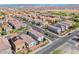 Expansive aerial view showcasing a well-planned community, featuring orderly streets, diverse homes, and mountain backdrop at 10025 San Floriano St, Las Vegas, NV 89178