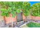 Tranquil backyard with lush landscaping including a modern water feature and mature trees at 10025 San Floriano St, Las Vegas, NV 89178