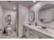 Well-lit bathroom features double sinks, framed mirrors, and modern fixtures plus a walk in shower at 10025 San Floriano St, Las Vegas, NV 89178