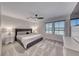Serene bedroom with a plush king bed, soft carpeting, ceiling fan, and plenty of natural light at 10025 San Floriano St, Las Vegas, NV 89178