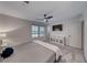 Cozy bedroom features neutral tones, a ceiling fan, plush carpeting, and ample natural light at 10025 San Floriano St, Las Vegas, NV 89178