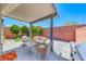 Charming covered patio with a cozy seating area and grill, perfect for outdoor dining and relaxation at 10025 San Floriano St, Las Vegas, NV 89178
