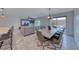 Open dining and living area with large dining table, large couch, and backyard access at 10025 San Floriano St, Las Vegas, NV 89178
