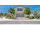 Charming two-story home features a well-manicured yard and a brick-paved driveway leading to an attached garage at 10025 San Floriano St, Las Vegas, NV 89178