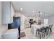 Modern kitchen with stainless steel appliances, white cabinets, and seating at the island at 10025 San Floriano St, Las Vegas, NV 89178