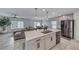 Modern kitchen with white cabinets, stainless steel appliances, and backyard access at 10025 San Floriano St, Las Vegas, NV 89178