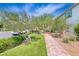 Scenic pathway lined with lush greenery, mature trees, and manicured lawn offering a serene outdoor experience at 10025 San Floriano St, Las Vegas, NV 89178