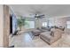Spacious living room featuring comfortable seating, large windows, and a stylish TV, perfect for relaxation and entertainment at 10025 San Floriano St, Las Vegas, NV 89178