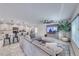 Open-concept living room features a large sectional couch, ceiling fan, and backyard access at 10025 San Floriano St, Las Vegas, NV 89178