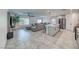 Open concept living space with a kitchen island, stainless steel appliances and large couch at 10025 San Floriano St, Las Vegas, NV 89178