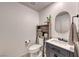 Stylish powder room features a vessel sink, storage cabinet, modern fixtures, and decorative mirror at 10025 San Floriano St, Las Vegas, NV 89178