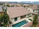Aerial view of the backyard with a swimming pool, patio area with furniture, and landscaped surroundings at 1005 Old Creek Way, North Las Vegas, NV 89084