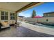 Inviting outdoor living space with a sparkling pool, red umbrella, and patio area at 1005 Old Creek Way, North Las Vegas, NV 89084