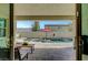 Inviting outdoor living space with a sparkling pool, red umbrella, and patio area perfect for relaxation at 1005 Old Creek Way, North Las Vegas, NV 89084