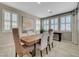 Elegant dining room with a large wooden table, comfortable chairs, and plantation shutters on the windows at 1005 Old Creek Way, North Las Vegas, NV 89084