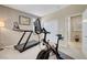 Exercise room with treadmill and exercise bike, and door leading to hall at 1005 Old Creek Way, North Las Vegas, NV 89084