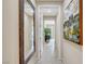 Bright hallway with neutral colors, a decorative mirror, and an inviting view of other rooms at 1005 Old Creek Way, North Las Vegas, NV 89084