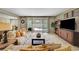 Open-concept living room with views of the outdoor pool and dining area at 1005 Old Creek Way, North Las Vegas, NV 89084