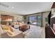 Cozy living room with comfortable seating, a large rug, and sliding glass doors to the backyard at 1005 Old Creek Way, North Las Vegas, NV 89084