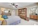 Inviting main bedroom with an ensuite bathroom featuring a large bookshelf and a ceiling fan at 1005 Old Creek Way, North Las Vegas, NV 89084