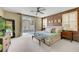 Spacious main bedroom featuring a unique accent wall, a ceiling fan, and access to the backyard at 1005 Old Creek Way, North Las Vegas, NV 89084