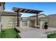 Outdoor kitchen features stainless steel grill, granite countertop, and pergola at 1005 Old Creek Way, North Las Vegas, NV 89084