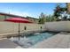 Relaxing pool features stone accents, water features, and a red umbrella at 1005 Old Creek Way, North Las Vegas, NV 89084