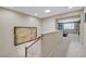 Upstairs hallway with painting and view into game room at 1005 Old Creek Way, North Las Vegas, NV 89084