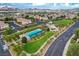 Community aerial view featuring a pool, playground, green spaces, and well-maintained homes with mountain views at 1055 Fish Pond Ave, Henderson, NV 89014