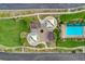 Overhead view of neighborhood park featuring pool, splash pad, playground, picnic area, and green area at 1055 Fish Pond Ave, Henderson, NV 89014