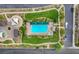 Aerial view of a community pool, splash pad, playground, picnic area, and green area at 1055 Fish Pond Ave, Henderson, NV 89014