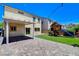 Backyard featuring a covered patio with pavers, a playhouse on a synthetic lawn, and string lights at 1055 Fish Pond Ave, Henderson, NV 89014