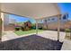 The backyard features a covered patio, brick pavers and a play area with synthetic grass at 1055 Fish Pond Ave, Henderson, NV 89014