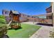 Backyard features a play structure and covered patio creating the perfect area for backyard fun at 1055 Fish Pond Ave, Henderson, NV 89014