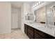 Double sink bathroom with dark cabinets and modern fixtures at 1055 Fish Pond Ave, Henderson, NV 89014