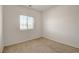 Bright bedroom with a window bringing in natural light and neutral carpet and fresh, clean paint at 1055 Fish Pond Ave, Henderson, NV 89014