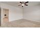 Well-lit bedroom features a ceiling fan and neutral carpeting at 1055 Fish Pond Ave, Henderson, NV 89014
